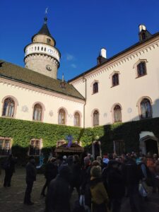 Pohled na část zámku Sychrov s mumrajem lidí na nádvoří